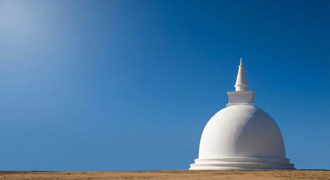 The striking white stupa, a symbol of Sri Lankan Buddhist culture and heritage, stands prominently against a vivid blue sky, representing the nation's spiritual depth and celebrating Sri Lanka Indepe
