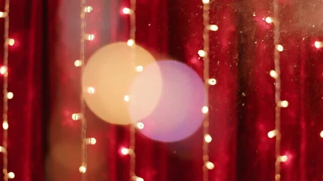 Decorative string lights against red fabric backdrop