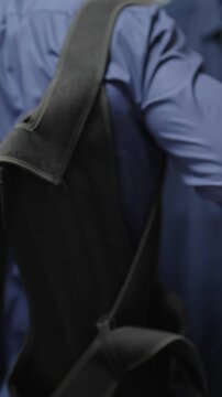 Headless person dressing up in bedroom put on posture belt
