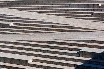 Stairs and steps on a concrete staircase create an urban architecture pattern with strong texture, geometric perspective, and clean lines.
