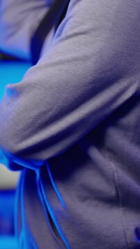 Headless male gamer put on posture belt in cyber background