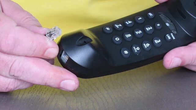 Connecting the cable properly on a landline telephone in a home setting 80s 90s