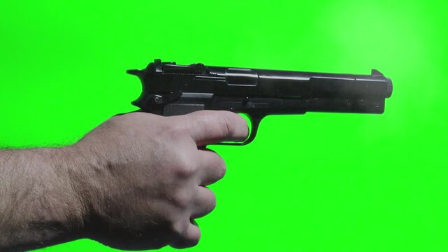 Gun fires three shots in close up with green screen background