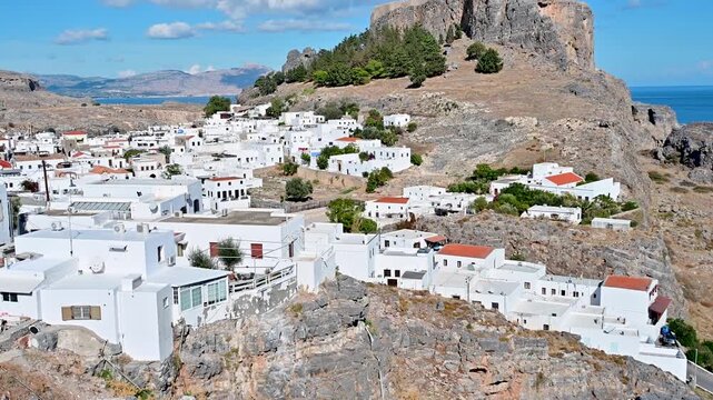 Lindos town and acropolis above hillside on Rhodes, Greece