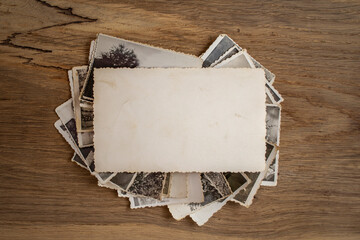 Stacked old photos backside with blank copy space , on repurposed oak wood texture background. abstract textured backdrop, invitation mockup