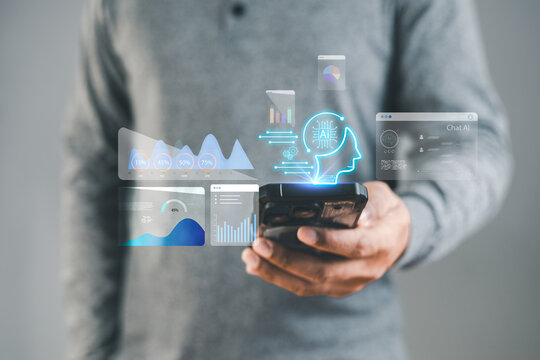 Businessman holding smartphone with virtual AI chatbot and analytics interface. Artificial intelligence technology concept showing smart digital assistant, data analysis, and futuristic innovation. - Powered by Adobe