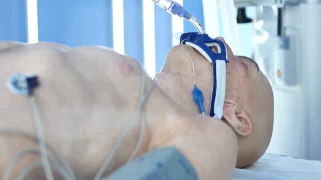 Unconscious patient on life support in hospital intensive care unit