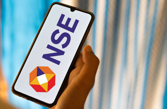 nse mobile app concept with hand holding smartphone displaying national stock exchange logo.