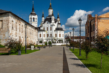 A street in a recreation park in a small Siberian town, bathed in autumn sunshine. At the end of...