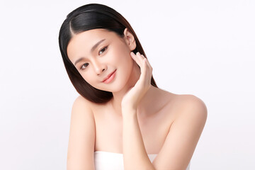 A beautiful young Asian woman with clean, fresh skin against a white background. Skincare, facial treatment, cosmetology, beauty, and spa. An elegant portrait of an Asian woman.