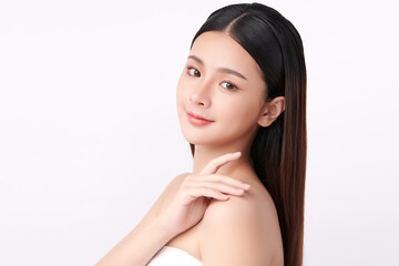 A beautiful young Asian woman with clean, fresh skin against a white background. Skincare, facial treatment, cosmetology, beauty, and spa. An elegant portrait of an Asian woman.