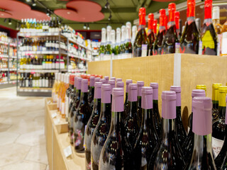 defocused alcohol (wine, champagne, liquor, whiskey) on store shelves