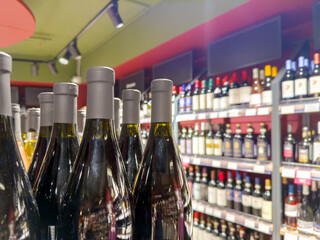 defocused alcohol (wine, champagne, liquor, whiskey) on store shelves