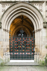 Manchester cathedral  Entrance With Ornate Archway And Planters On Quiet Urban Street