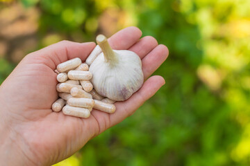 Garlic in supplements on the table. Selective focus.