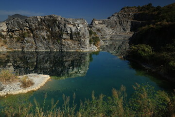 Blue Lagoon ,a large emerald-blue pond surrounded by limestone mountains. It is 70 meters deep and was created by releasing water after the stone mill stopped  mining. 
Phu Pha Man ,Khon Kaen,THAILAND