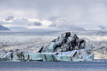 Beautiful blue icebergs reflected in the Jokulsarlon glacial lagoon, Southern Iceland. Part of the Vatnajokull National Park and Vatnajokull glacier, the largest glacier in Europe.