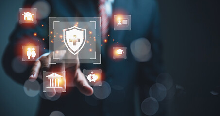 Businessman selecting a digital insurance shield icon surrounded by other icons.