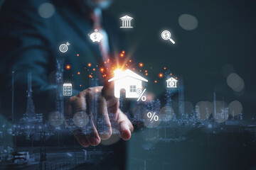 A businessman selecting a digital home icon with a percentage symbol.