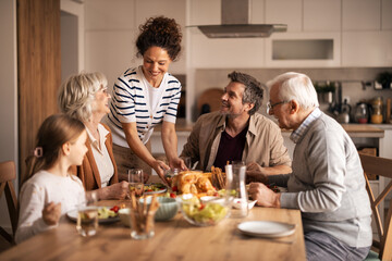 Happy multi-generational family enjoying festive lunch together