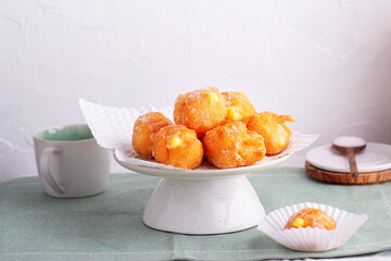 Carnival brighelle or fried cream puffs with custard