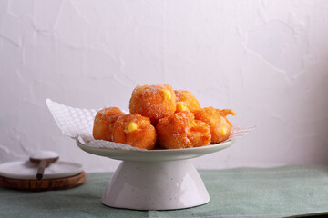 Carnival brighelle or fried cream puffs with custard