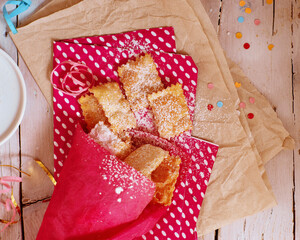 Italian carnival fritters dusted with powdered sugar. Selective focus. With free text space.