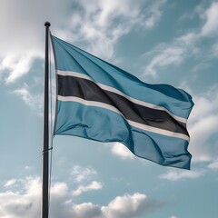 The flag of Botswana waving in the wind against a cloudy sky