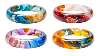 Four vividly colored, translucent, circular bracelets with marbled patterns against a black background