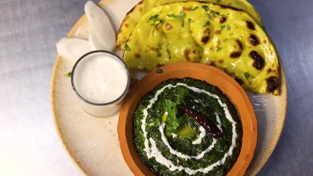 Makke ki roti sarso ka saag with buttermilk garnished with cream and butter