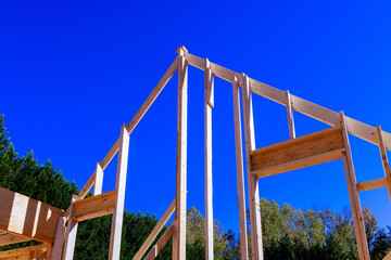 Workers are constructing wooden beams frame for building setting.