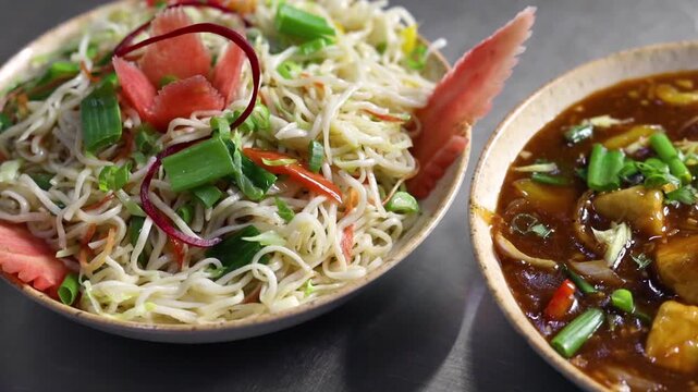 Paneer manchurian with noodles indo chinese dish garnished with spring onions 