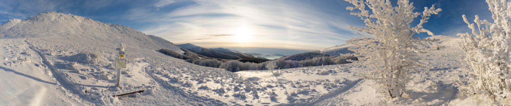 Ultra-wide panoramic winter view along the Tarnica&ndash;Halicz&ndash;Rozsypaniec hiking trail in the Bieszczady Mountains. Frozen landscape, snow-covered ridges, extreme cold, sunrise light and vast wilderness d
