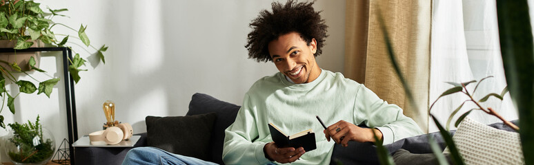 Handsome young man enjoys quiet moments of creativity in a cozy modern living space © Bliss