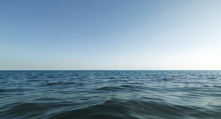 Obraz premium Wide, tranquil ocean expanse under a clear, cloudless blue sky, a calming seascape