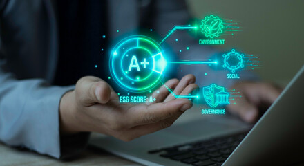 Businessman holding hologram showing ESG Score A+ rating with Environment, Social, and Governance icons. Concept of high-standard sustainable business and ethical corporate responsibility.