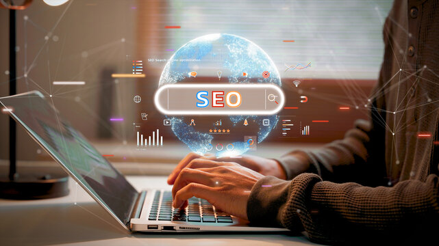 A person using a laptop with a glowing digital holographic SEO search bar and global networking icons symbolizing search engine optimization and digital marketing strategy in a modern workspace - Powered by Adobe