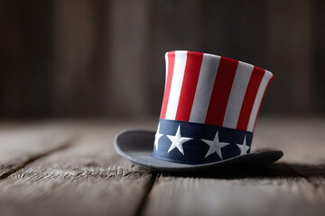 Red, white, and blue patriotic hat on wooden table background  