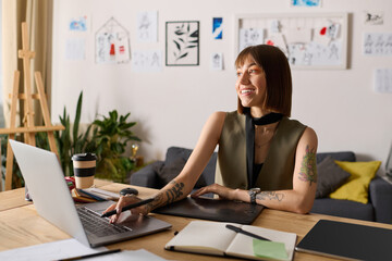 Creative young woman enjoys artistic moment at home workspace with laptop and sketches
