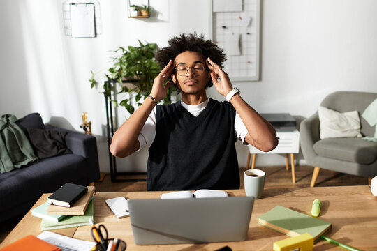 Modern young man finding peace while working in his cozy home environment