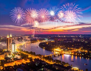 Stunning aerial view showcasing vibrant fireworks over a cityscape at twilight. A river winds through, reflecting city lights