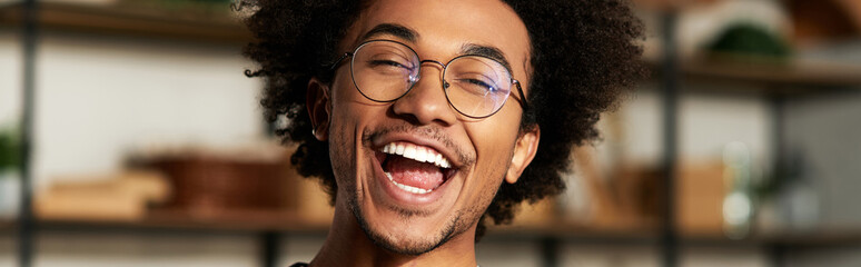 Joyful moments in a cozy modern home with a young african american man smiling brightly
