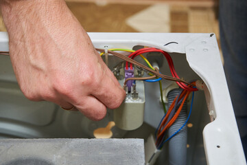 connecting electrical wiring by hand inside a washing machine, Repairing or installing electrical connections in a washing machine