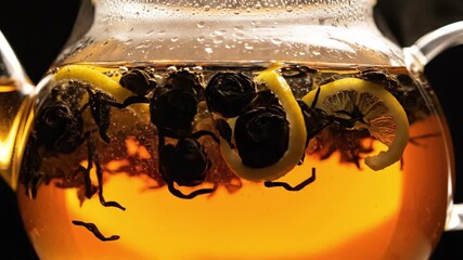 Warm sunlight fills a charming kitchen as black tea brews with slices of lemon and a burst of berries. The aromas create a welcoming atmosphere perfect for relaxation and connection.
