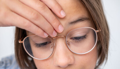 Close-up portrait teenage boy touching head with pain, suffering from headache or concussion,...