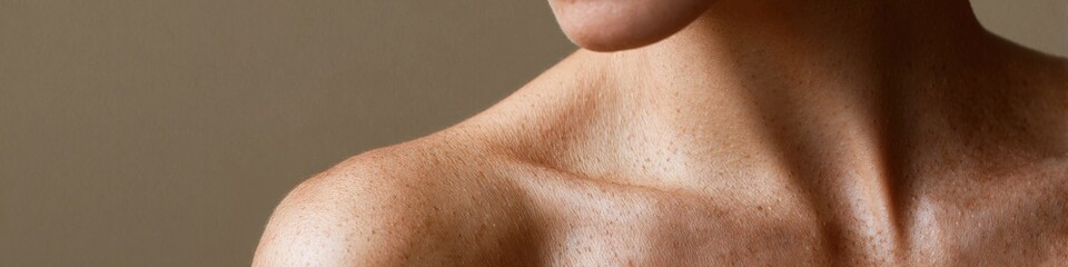 Fototapeta premium Close-up of caucasian female neck and shoulder with freckles