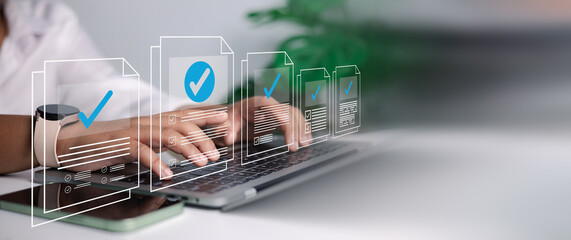 Businessman hands typing on laptop with virtual checked document icons. Concept of online approval, digital verification, compliance, and quality control in modern office workflow.