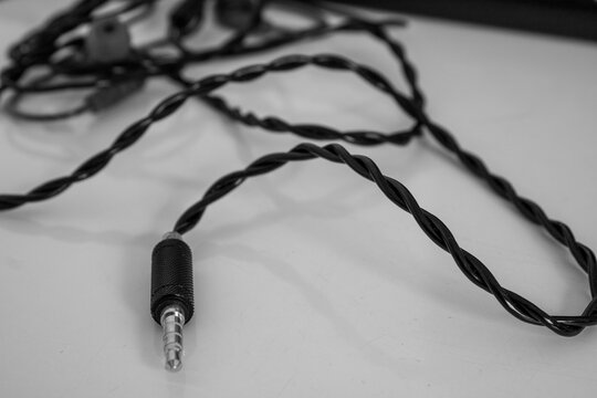 Black and White Close-Up of Twisted Audio Cable with 3.5mm Jack Connector