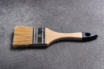 Close-up of a paint brush on a gray background