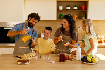 Happy family enjoying breakfast together in kitchen